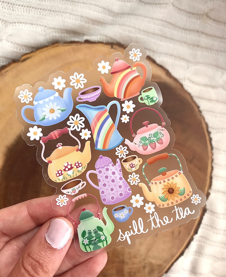 May include: A clear sticker sheet with colorful teapots and cups, flowers, and the text "spill the tea".
