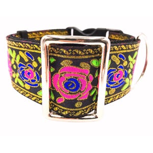 May include: Black dog collar with a silver buckle and a floral pattern featuring pink, blue, and green roses. The collar has a gold trim.
