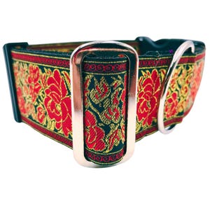 May include: A black dog collar with a red and gold floral pattern and a silver buckle.