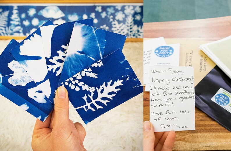 May include: A set of five cyanotype prints featuring white leaf silhouettes on a blue background. The prints are held in a hand and are accompanied by a handwritten note that reads "Dear Rosie, Happy birthday I know that you will find something from your garden to print! Have fun, lots of love, Sam xxx".