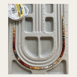 Necklace with rondelle gemstone beads in the colors brown red orange yellow gray and white