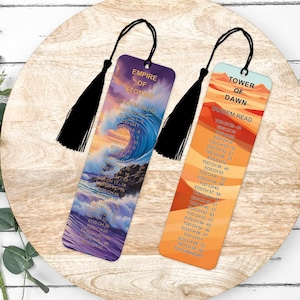 May include: Two colourful bookmarks with a fantasy theme. The bookmark on the left features a purple and blue wave with the text "Empire of Storms" and "Tandem Read". The bookmark on the right features a desert scene with the text "Tower of Dawn" and "Tandem Read".