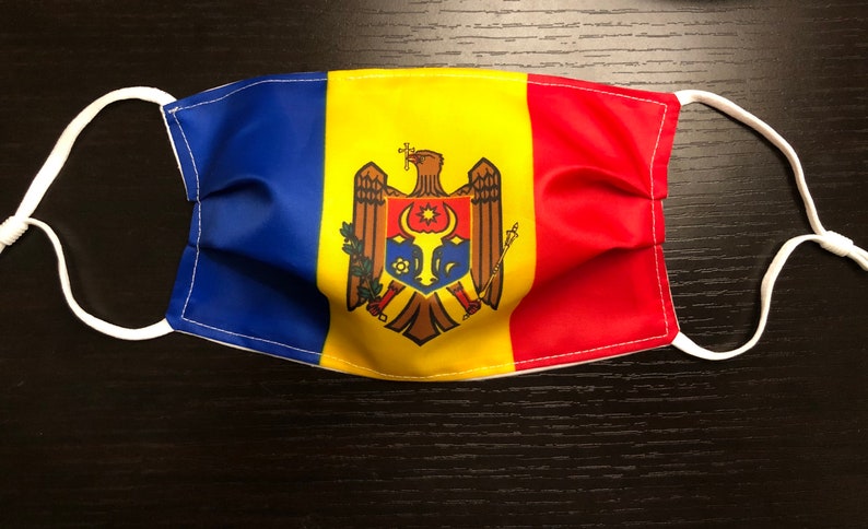 Pu&ograve; includere: Una maschera facciale blu, gialla e rossa con lo stemma della Moldavia stampato su di essa.