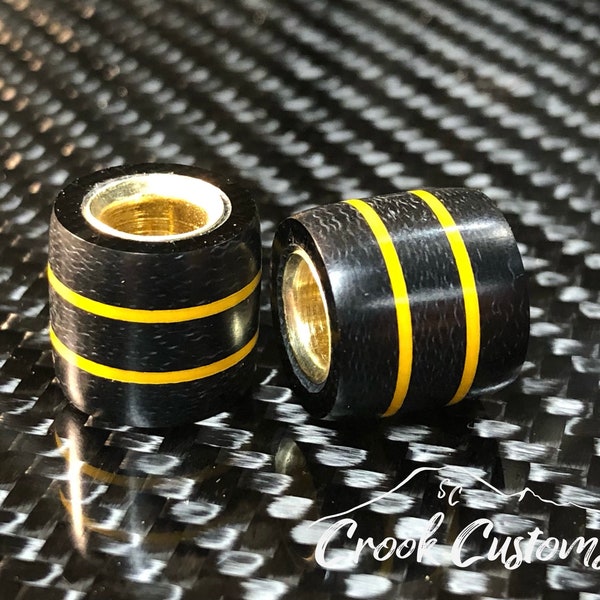 EDC Paracord lanyard bead Black Micarta, yellow spacers, and brass. Handmade in the USA.
