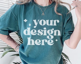 May include: A teal blue oversized t-shirt with the text "your design here" in white. The shirt is made of a soft, comfortable material and has a relaxed fit.