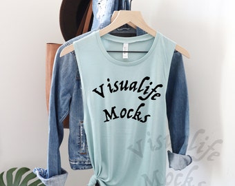 May include: A light blue sleeveless shirt with the text "Visuallife Mocks" printed in black on the front.