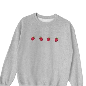 May include: A gray sweatshirt with a row of five red raspberries embroidered on the front.