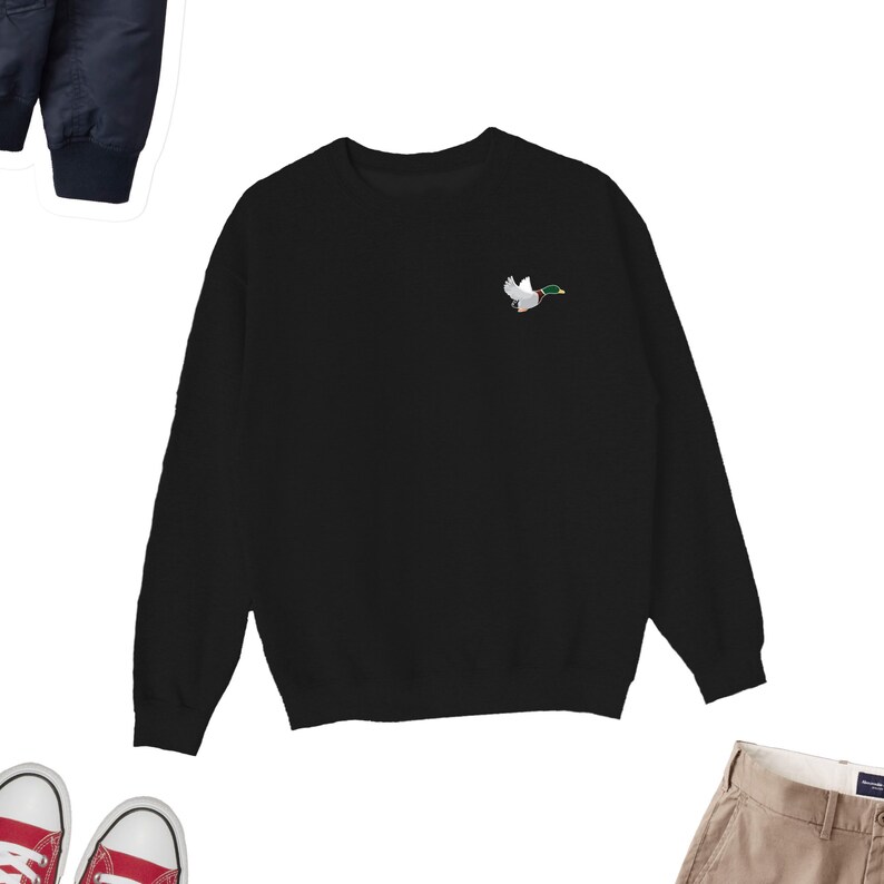 May include: Black sweatshirt with a small embroidered image of a flying duck on the left chest.