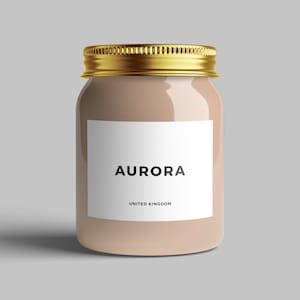 May include: A beige glass jar with a gold lid and a white label that says "AURORA UNITED KINGDOM".