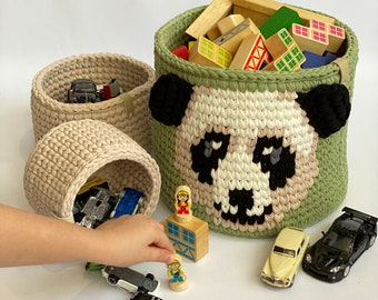 Large knitted basket with handles, featuring a dog print, is placed in the nursery for storing toss toys. Nursery Storage.Panda basket