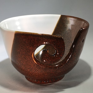 Brown and White Yarn Bowl perfect for assisting in your knitting or crocheting. Keeps the yarn from tangling up, feeds it out evenly.