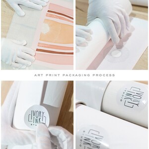 May include: A white art print is being rolled up and packaged in a white tube with a white label that says "Ivory Ink Studio".