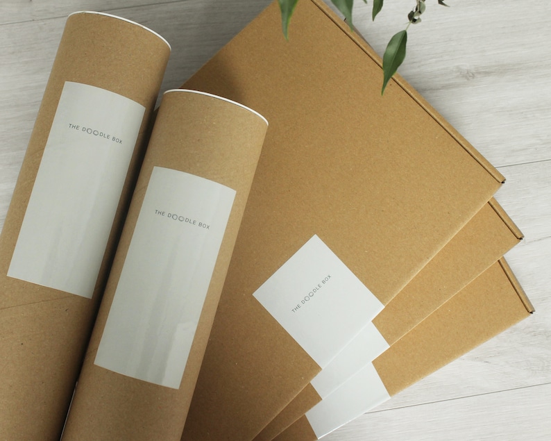 May include: Three brown cardboard boxes with white labels that say "The Doodle Box". Two of the boxes are rolled into tubes.