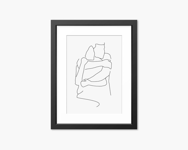 May include: A black framed print of a line drawing of two people hugging. The drawing is in a minimalist style and is on a white background.