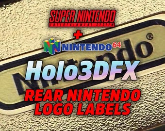 May include: Close-up of a gold-colored Nintendo 64 logo label with the text "Holo3DFX" and "Rear Nintendo Logo Labels." The image also includes the Super Nintendo Entertainment System logo.