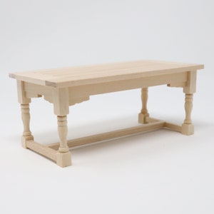 May include: A wooden table with a rectangular top and four turned legs. The table is made of unfinished wood and has a simple, rustic design.