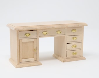 May include: A light wood desk with six drawers and a cabinet door. The desk has gold-colored metal handles.