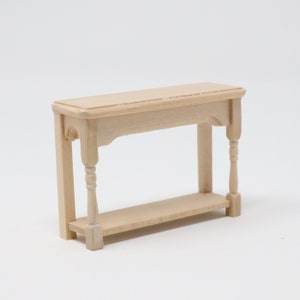 May include: A small, unfinished wooden table with a shelf. The table has turned legs and a simple design.