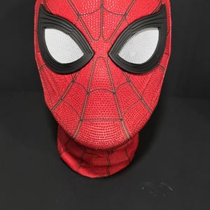 May include: A red Spider-Man mask with black accents and white mesh eye coverings. The mask features a textured surface and a web-like pattern. The mask is a cosplay item.