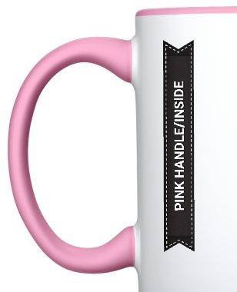 May include: White ceramic mug with a pink handle and rim. The mug has a black banner with the text "PINK HANDLE/INSIDE" printed on it.