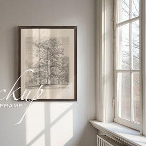 May include: A framed black and white illustration of a tree in a forest setting. The frame is brown wood with a white mat. The illustration is hanging on a white wall.