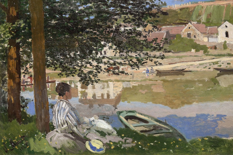 May include: A woman in a striped shirt sits on the bank of a river, looking out at the water. A small boat is in the water, and there are buildings and trees in the background.