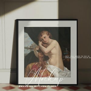 May include: A black picture frame with a white mat and a painting of a woman with long red hair. The frame is on a tiled floor with a white wall in the background. The text "ALL YOU NEED TO DO IS DRAG AND DROP YOUR ARTWORK" is visible in the bottom right corner of the frame.