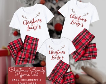 May include: A Christmas family pajama set with red and black plaid pants and white t-shirts with the text "Christmas with the Lacey's" printed on them.