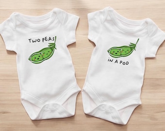 May include: Two white baby onesies with short sleeves. One onesie has the text "Two Peas" and a graphic of a smiling pea pod. The other onesie has the text "In a Pod" and a similar pea pod graphic.
