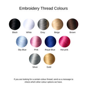 May include: A color chart displaying embroidery thread colors. The chart includes black, white, grey, beige, and brown. Additional colors are sky blue, pink, royal blue, hot pink, silver, and gold. Text at the bottom encourages inquiries about other color options.