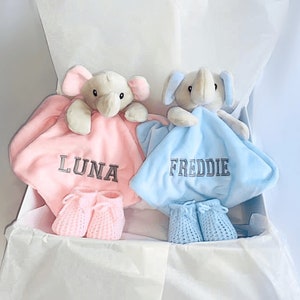 personalised newborn twin gift, includes two elephant comforters personalised and wool knitted baby booties. Choose from pink, white, grey or blue colour options. dark grey named embroidery. baby twin arrival gift.