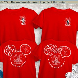May include: Red t-shirts with white graphic designs. The front of the shirts feature a Mickey Mouse and castle design with the text "The Happiest Place on Earth." Some shirts have names printed on them. The image includes a pair of jeans and sneakers.