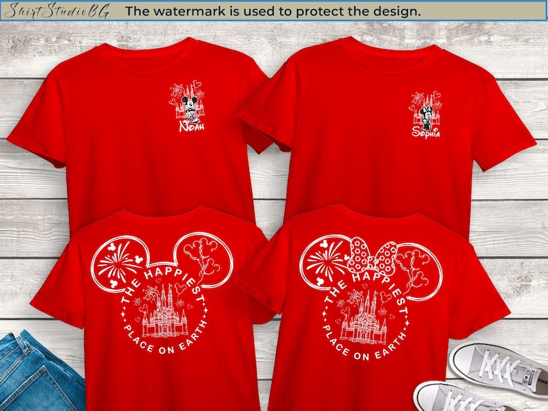 May include: Red t-shirts with white graphic designs. The front of the shirts feature a Mickey Mouse and castle design with the text "The Happiest Place on Earth." Some shirts have names printed on them. The image includes a pair of jeans and sneakers.