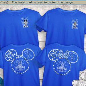 May include: Four blue t-shirts with white graphic designs. Two shirts have a Mickey Mouse and castle design with names, and the other two feature a Mickey Mouse head with the text "The Happiest Place on Earth" and a castle.