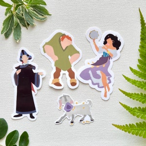 May include: Set of four stickers featuring stylized illustrations of characters from a classic animated film. Includes figures of a hunchbacked man, a woman dancing with a tambourine, a goat, and a man in a black robe.