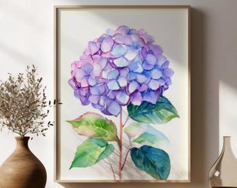 May include: Watercolor painting of a hydrangea flower in shades of purple and blue, framed in a light wood frame. The artwork is displayed on a wooden table, with a brown vase and a clear glass vase on either side.