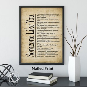 May include: A framed print with the song lyrics "Someone Like You" on a vintage-style background. The print is in a black frame and includes the text "Mailed Print" at the bottom.
