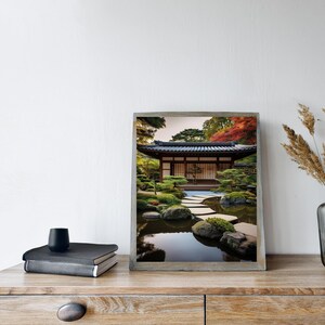May include: A framed photograph of a Japanese garden with a traditional wooden house, a stone path, and a pond with reflections of the trees and sky.