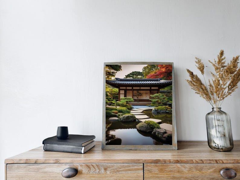 May include: A framed photograph of a Japanese garden with a traditional wooden house, a stone path, and a pond with reflections of the trees and sky.