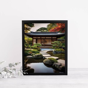 May include: A black framed photograph of a Japanese garden with a traditional wooden building, a stone path leading to a pond, and lush greenery.