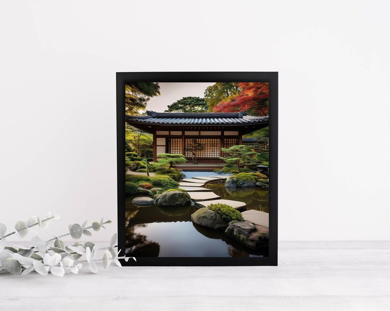 May include: A black framed photograph of a Japanese garden with a traditional wooden building, a stone path leading to a pond, and lush greenery.