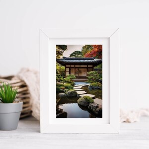 May include: A white frame with a photograph of a Japanese garden. The garden features a traditional wooden building with a pond and stone stepping stones.