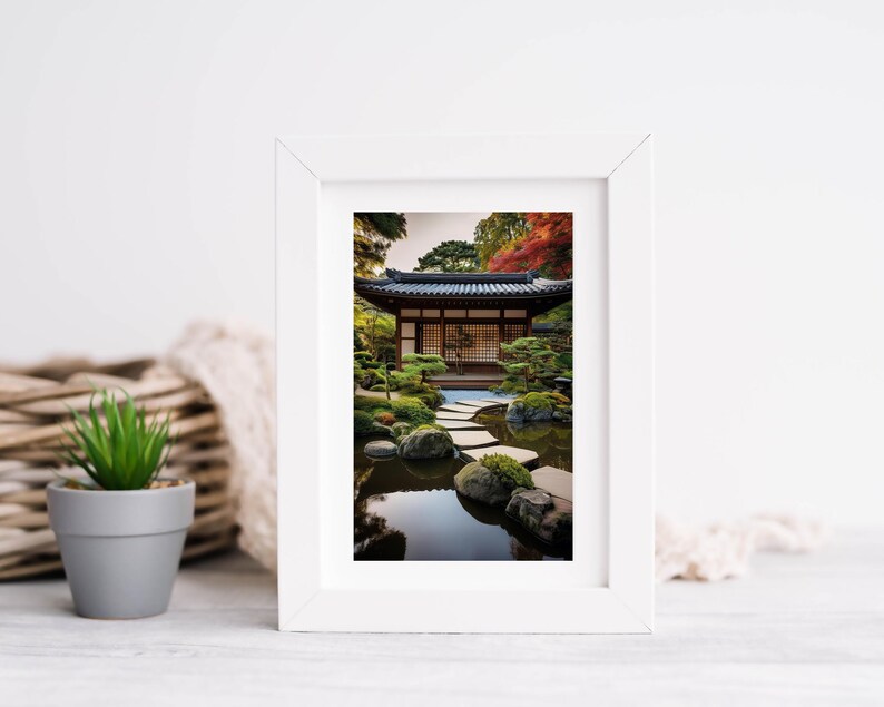May include: A white frame with a photograph of a Japanese garden. The garden features a traditional wooden building with a pond and stone stepping stones.