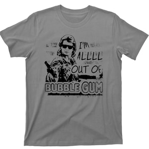May include: A gray t-shirt with a black and white graphic print of a man with the text "I'm All Out Of Bubble Gum".