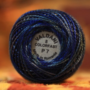 May include: A blue and green ball of yarn with a white label that reads "Waldani 8 Colorfast P7 Made in Romania".