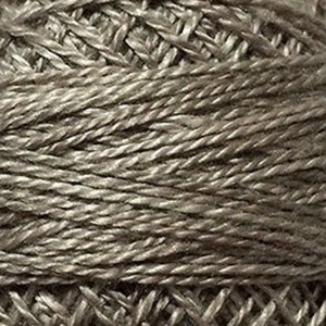 May include: Close-up of a spool of gray embroidery floss.