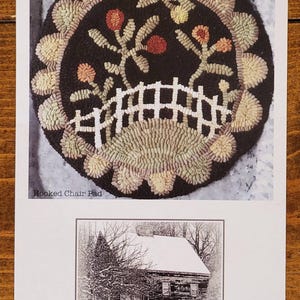 May include: A printed pattern for a hooked chair pad with a floral design, featuring a black background, white fence, and tan and red accents. Below is a black and white image of a winter cottage with the text "Winter Cottage".