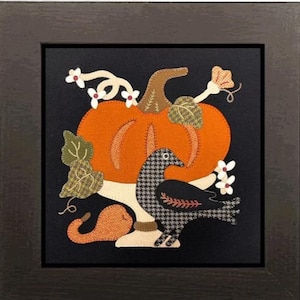 May include: A framed autumn-themed artwork featuring a large orange pumpkin with a brown stem, a black and white patterned crow, and decorative leaves and flowers. The artwork is set against a black background.
