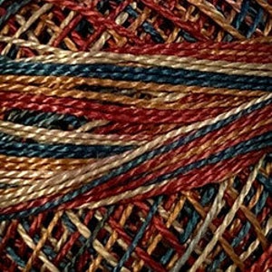 May include: Close-up of a multi-colored yarn skein with red, blue, brown, and cream colored threads.