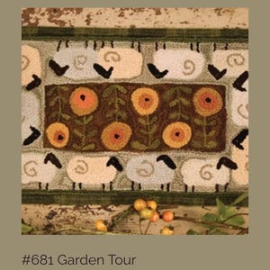 May include: A rectangular rug with a repeating pattern of sheep and flowers. The sheep are cream-colored with black faces and legs. The flowers are orange and yellow with green stems and leaves. The rug has a green border and the text "#681 Garden Tour".